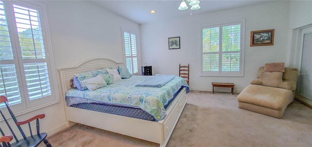 bedroom featuring light colored carpet, baseboards, and recessed lighting