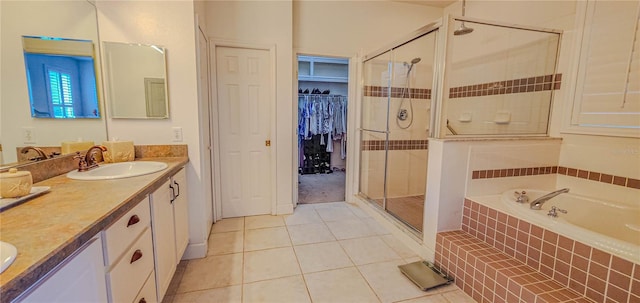 full bathroom with tile patterned floors, a shower stall, a bath, and double vanity