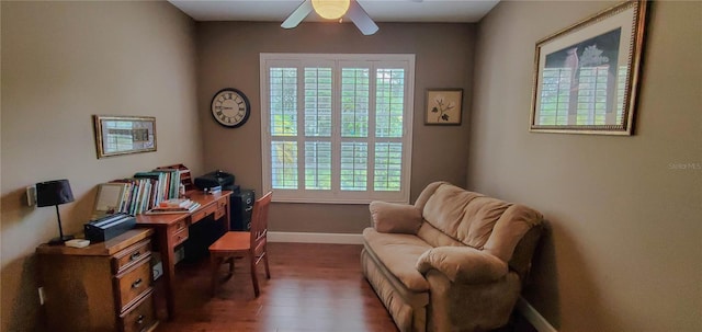 office space featuring healthy amount of natural light, wood finished floors, a ceiling fan, and baseboards