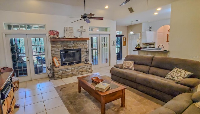 living area featuring french doors, ceiling fan, light tile patterned floors, recessed lighting, and arched walkways