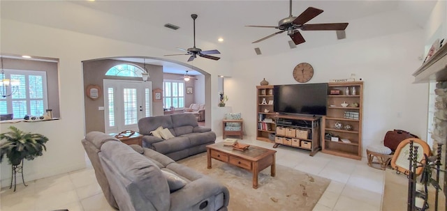 living room featuring arched walkways, a ceiling fan, light tile patterned floors, recessed lighting, and vaulted ceiling