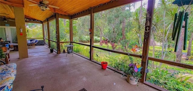 unfurnished sunroom with a ceiling fan, french doors, and vaulted ceiling
