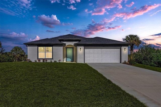 view of front of house with a lawn and a garage