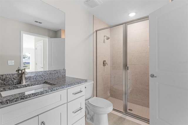 bathroom featuring vanity, toilet, and walk in shower