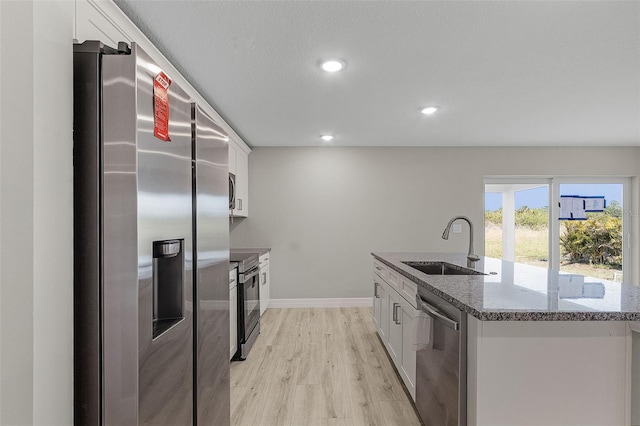 kitchen featuring sink, white cabinets, stainless steel appliances, and stone countertops