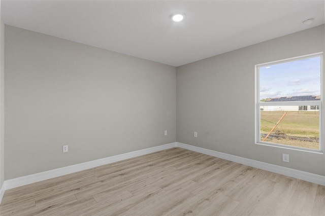 spare room with light hardwood / wood-style floors