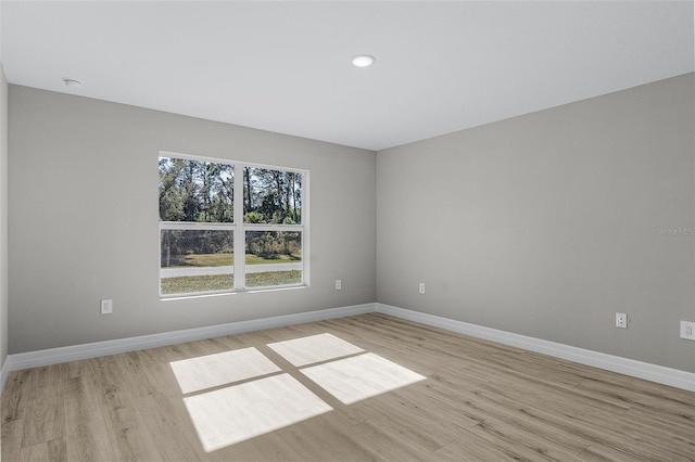 empty room with light hardwood / wood-style flooring