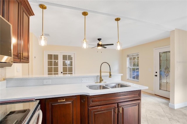 kitchen with ceiling fan, sink, french doors, stove, and pendant lighting