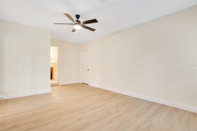 empty room with ceiling fan and light hardwood / wood-style flooring