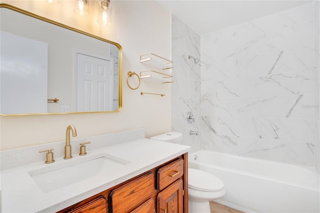 full bathroom with vanity, tiled shower / bath combo, and toilet