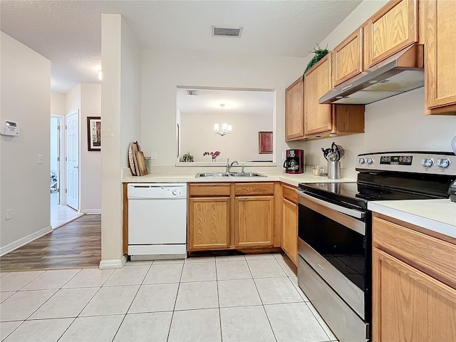 kitchen featuring stainless steel range with electric stovetop, an inviting chandelier, ventilation hood, white dishwasher, and sink