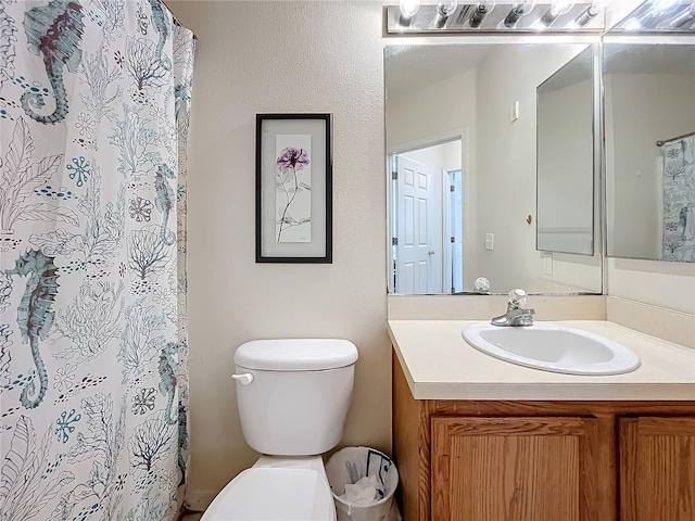 bathroom with vanity, toilet, and walk in shower