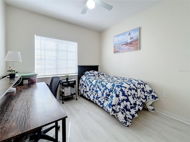 bedroom with ceiling fan and light wood-type flooring