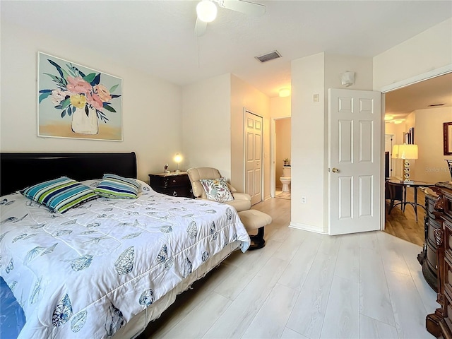 bedroom with connected bathroom, ceiling fan, and light hardwood / wood-style flooring