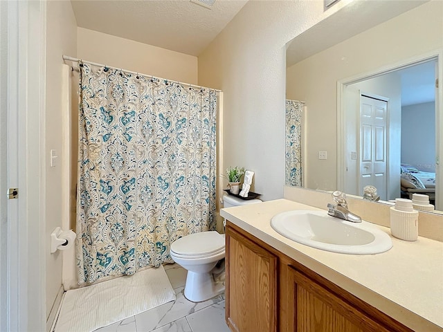 bathroom featuring vanity, a textured ceiling, and toilet