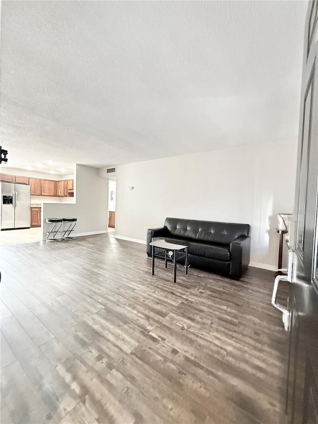 living room with hardwood / wood-style floors and a textured ceiling