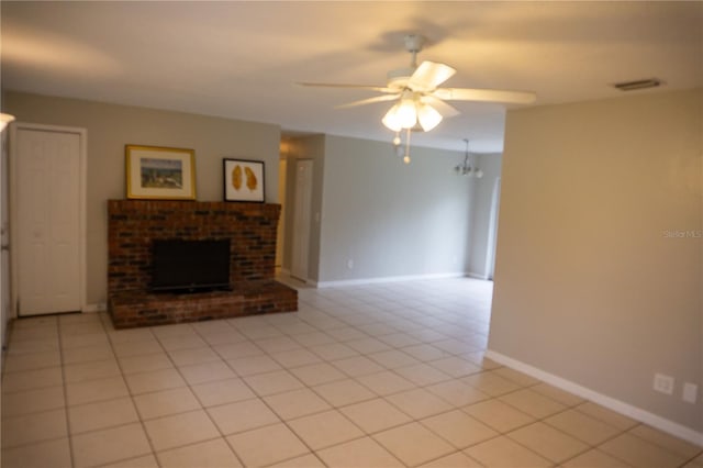 unfurnished living room featuring a fireplace, light tile patterned floors, and ceiling fan with notable chandelier