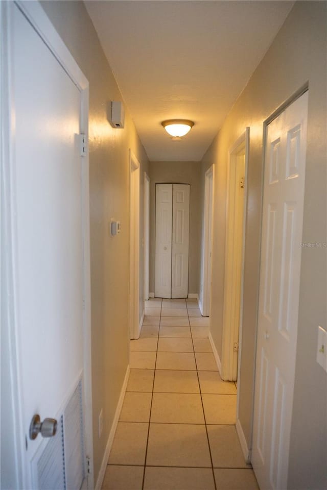 corridor with light tile patterned floors