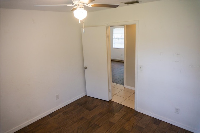 empty room featuring ceiling fan and hardwood / wood-style flooring