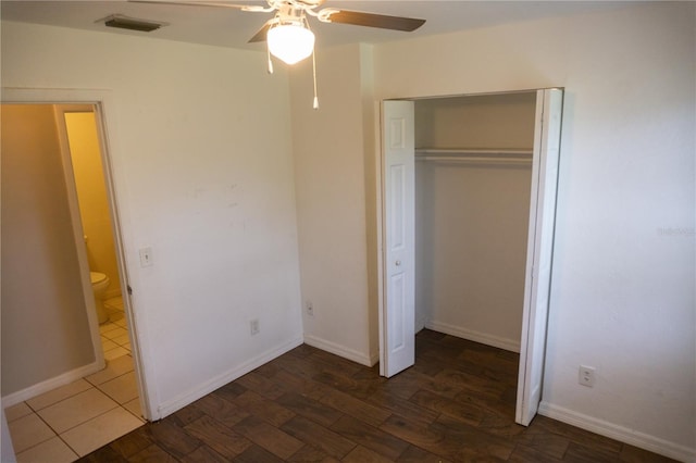 unfurnished bedroom featuring ceiling fan, dark wood-type flooring, and a closet