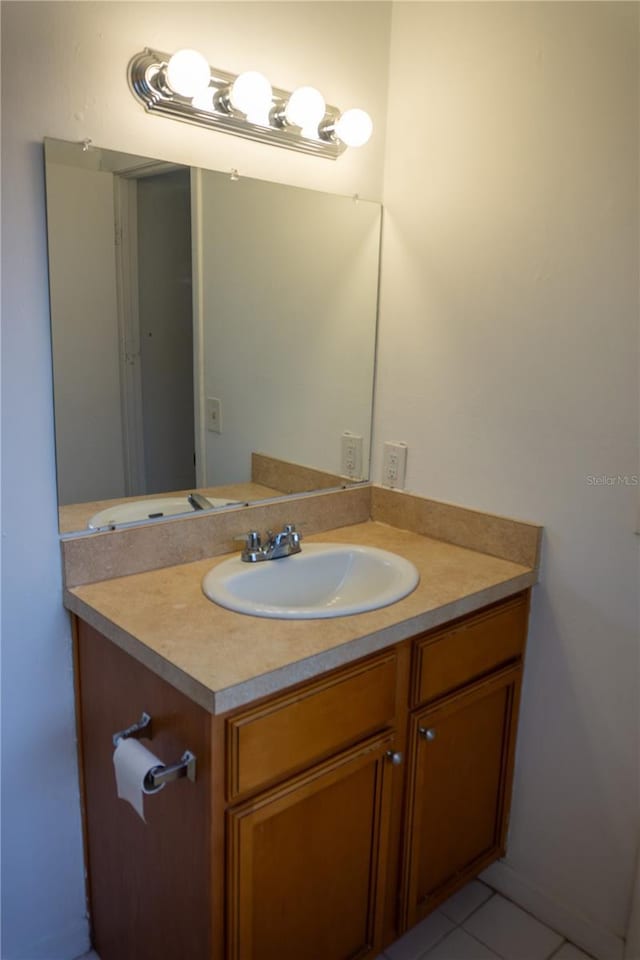 bathroom featuring tile patterned flooring and vanity