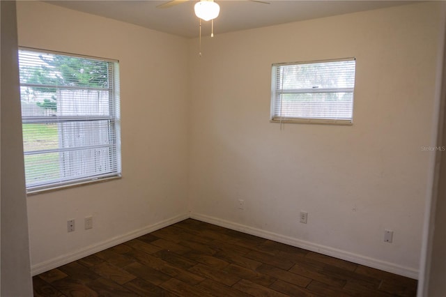 spare room with dark hardwood / wood-style floors and ceiling fan