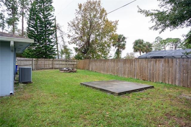 view of yard featuring cooling unit and a patio