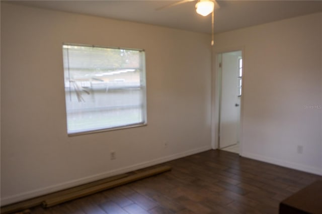 spare room featuring ceiling fan and dark wood-type flooring