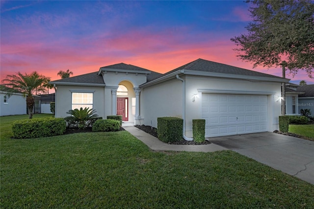 single story home featuring a yard and a garage