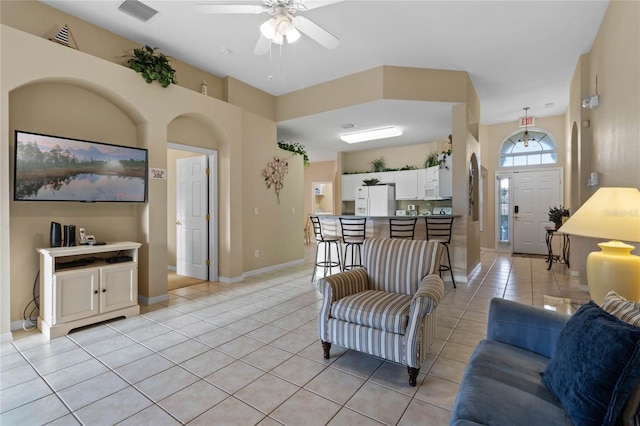 living room with light tile patterned floors and ceiling fan