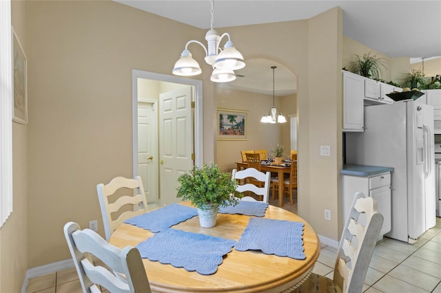 dining room featuring light tile patterned floors and a chandelier