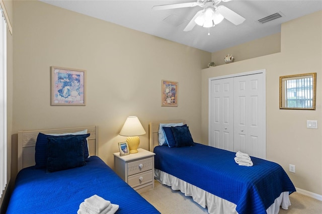 carpeted bedroom featuring a closet and ceiling fan