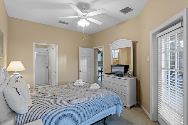 bedroom with ensuite bath, ceiling fan, and light colored carpet