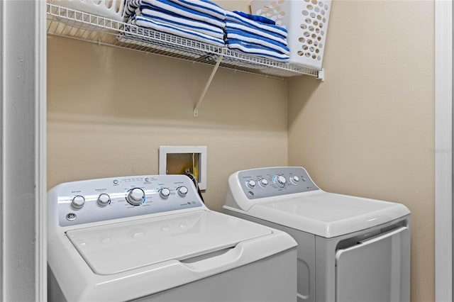 washroom with washing machine and clothes dryer