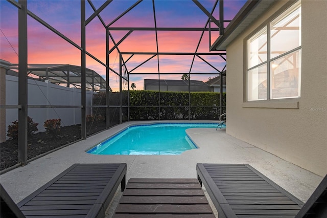 pool at dusk with a patio area