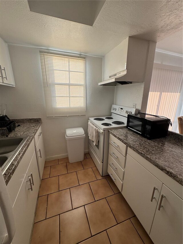 kitchen featuring white cabinetry, sink, white range with electric stovetop, a textured ceiling, and light tile patterned floors