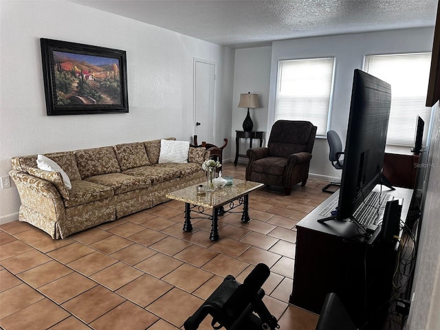 living room featuring tile patterned flooring and a textured ceiling