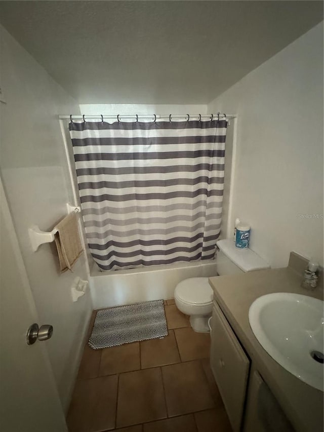 full bathroom featuring tile patterned flooring, shower / tub combo, vanity, and toilet