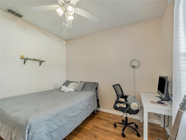 bedroom with ceiling fan and wood-type flooring