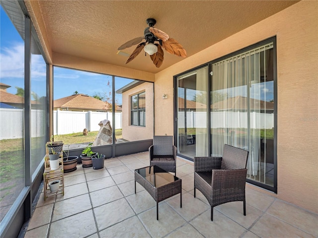 sunroom featuring a ceiling fan