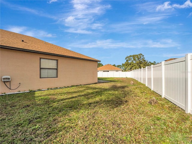 view of yard with a fenced backyard