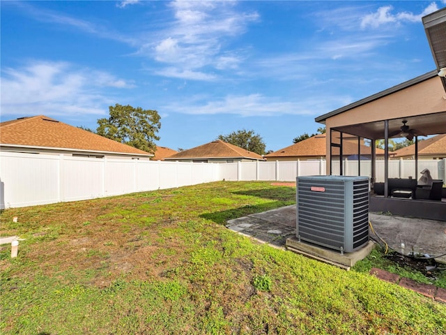 view of yard with a patio, central air condition unit, and ceiling fan