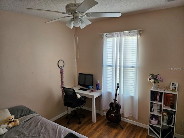 bedroom featuring visible vents, a ceiling fan, a textured ceiling, wood finished floors, and baseboards