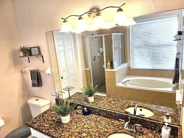 bathroom with a garden tub, vanity, and a shower stall