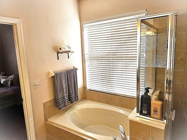 bathroom featuring separate shower and tub