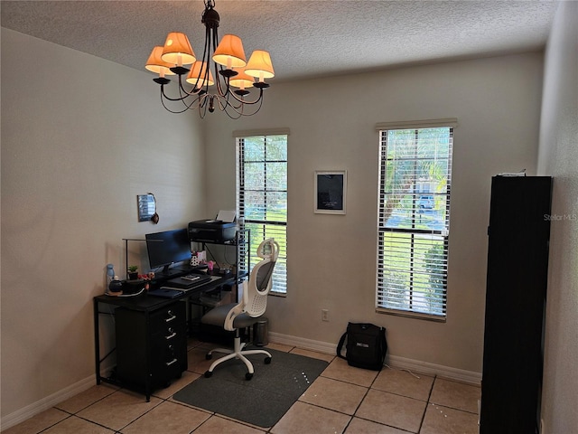 office space with light tile patterned floors, a textured ceiling, and a chandelier