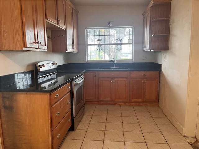 kitchen featuring light tile patterned floors, stainless steel electric range oven, and sink