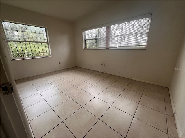 tiled empty room with a wealth of natural light