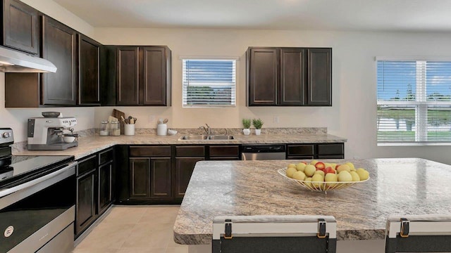 kitchen with light tile patterned floors, dark brown cabinetry, sink, and appliances with stainless steel finishes