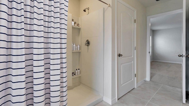 bathroom with tile patterned flooring and curtained shower